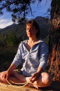 woman meditating by mountain