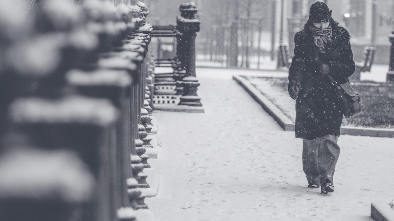 loneliness image, woman walking in rain