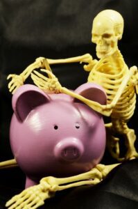 Skeleton and piggy bank
