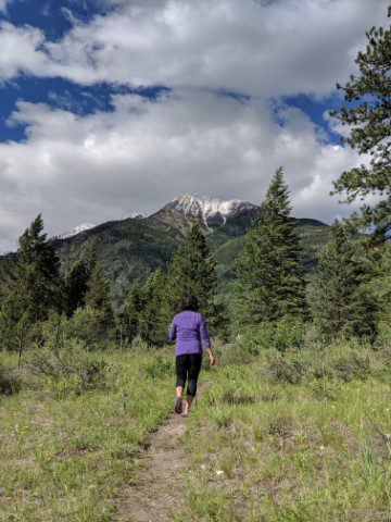 Woman hking up mountain at a meditation retreat center